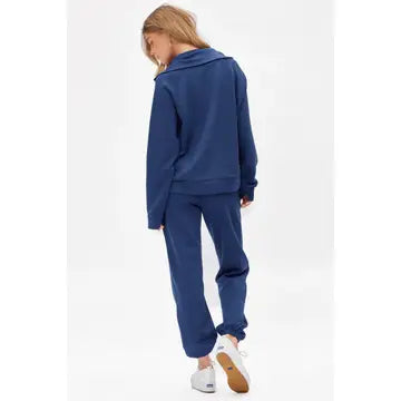 Person wearing a blue tracksuit on a white background