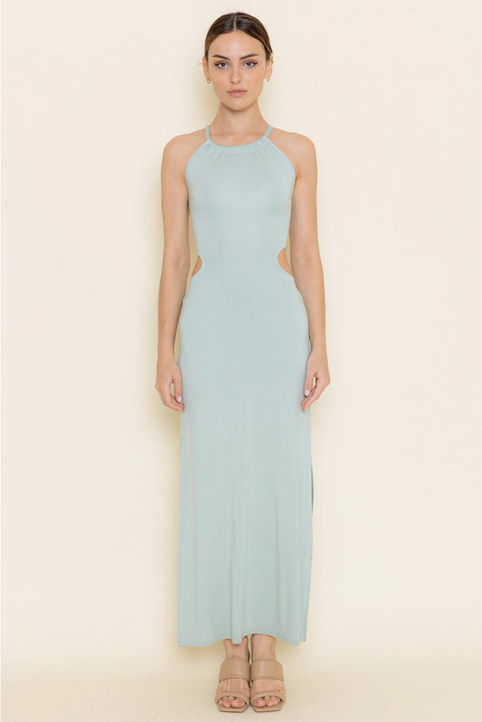 Woman wearing a light blue halter neck dress on a beige background