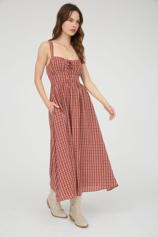 Woman wearing a red checkered dress on a white background