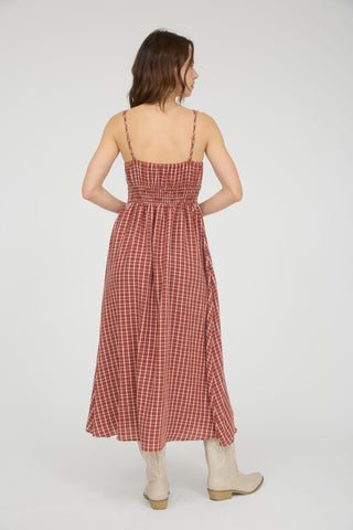 Woman wearing a red checkered dress on a white background
