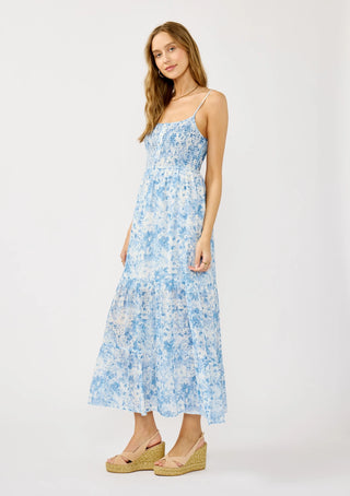 Woman wearing a blue floral dress on a white background