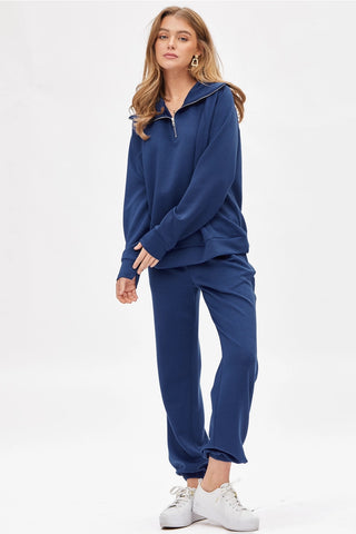 Woman wearing a blue tracksuit on a white background