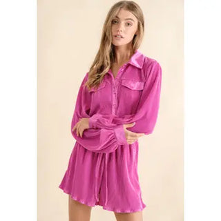 Woman wearing a pink satin nightshirt against a beige background