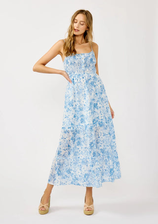 Woman wearing a blue floral dress on a white background