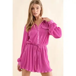 Woman wearing a pink dress with long sleeves on a beige background