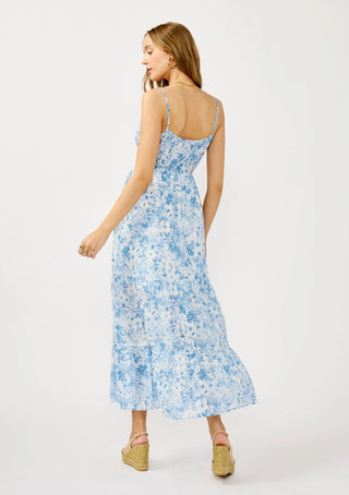 Woman wearing a blue floral dress on a white background