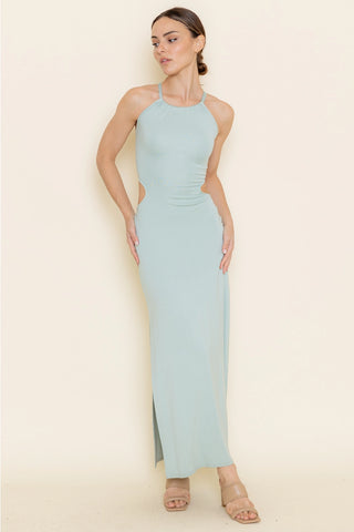 Woman wearing a light blue halter neck dress against a beige background