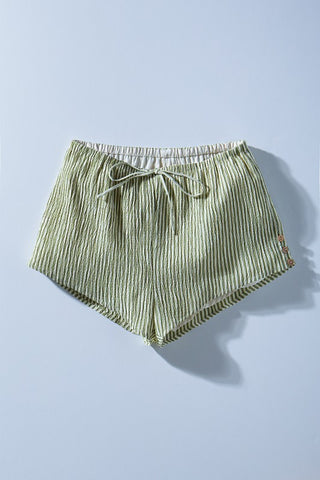 Green striped shorts on a light blue background